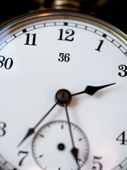 Antique old pocket watch dial close-up. Vintage hipster clock measuring time.