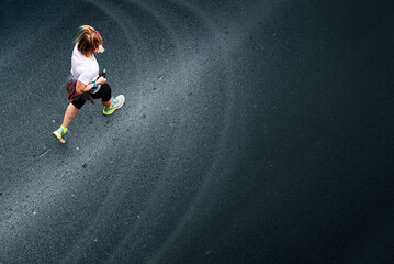Person running against asphalt