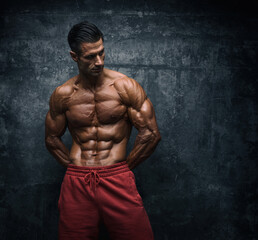muscular young man posing, flexing muscles