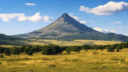 Fototapeta premium A solitary mountain peak rising above an untouched valley, far from civilization
