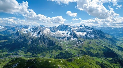 Naklejka premium A stunning aerial view of the Swiss Alps, with snow-capped peaks and green valleys