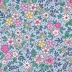 Romantic cute floral pattern in small flowers. Small pastel yellow and pink flowers. Blue background. Ditsy print. Floral seamless background. Gentle template for fashion prints. Summer Stock pattern