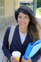 Elegant female student walking around in campus 