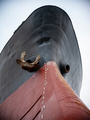 A cargo ship ran aground on the coast after a typhoon. Stranded ship is a huge risk of marine...