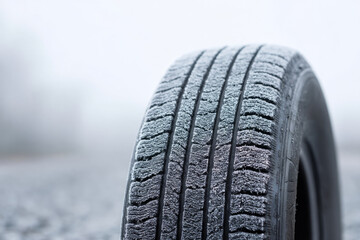 Frigid frost blankets neglected tire, whispering tales of icy adventure, winter solstice rituals, and the ancient art of tire craft