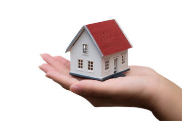 A miniature white house with a red roof is held in the palm of a hand against a black background scene on transparent background