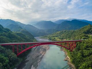 The bridge is surrounded by beautiful mountains and rivers, like a colorful ribbon, and it is more...