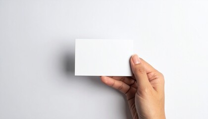 hand holding blank business card mockup isolated on white background