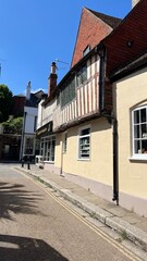 Historic Building With Timber Framing and Vibrant Storefront in a Quaint Village Setting Under Clear Blue Skies During Midday