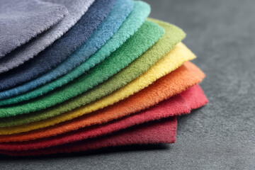 Multicolored suede fabric swatches fanned like rainbow petals, evoking patchwork quilt warmth, perfect for National Quilting Day inspirations