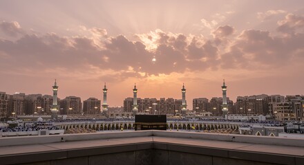 Kaaba in Mecca during sunset with city buildings