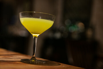 Elegant Yellow Cocktail in a Martini Glass – Night Bar Ambience