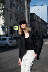 Obraz premium street style fashion girl model in a stylish look on the street.