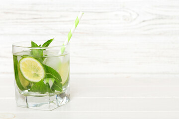 Mojito cocktail. Refreshing mojito cocktail with lime, lemon and mint in a tall glass with a stick