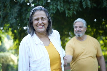 Obraz premium Indian happy senior couple fun, relaxing, spend time together at park. Relationship and people concept. Senior Living Retirement and Pension Plans Concept
