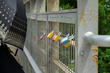 Colorful Padlocks Attached to a Metal Fence