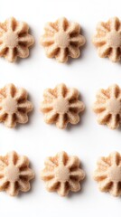 Overhead flat lay of nine star shaped cookies on white background in a pattern for food photography and baking concepts