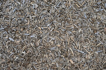 Wood chips. Texture for covering landscapes from grass and moisture. Recycling from trees, cyclicality of natural resource use.