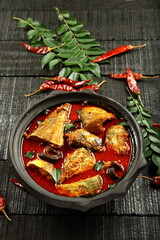 Top view- delicious home cooked fish curry in spicy gravy.