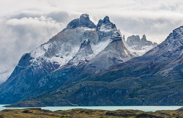Classic Patagonian landscape featuring the iconic Cuernos del Paine and French Valley mountains...
