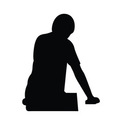 Silhouette of a person kneeling or leaning over a surface in black