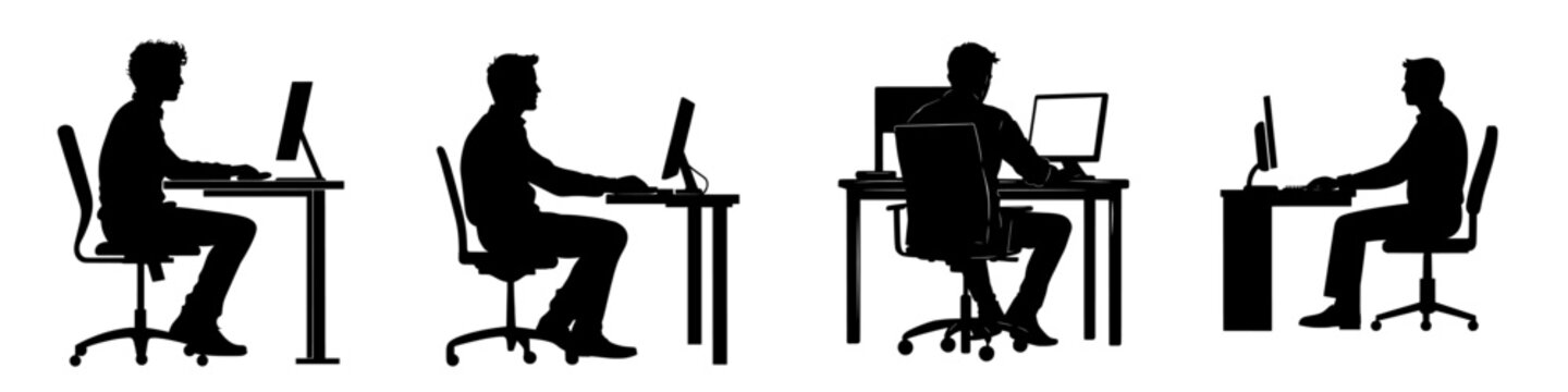 A man is seated on an office chair at a table, working on a computer