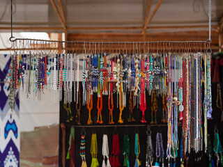 Souvenir shop. A random accessories local souvenir shop in Bukhara bazaar street market including color necklaces and bracelets made from precious stones and beads.