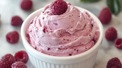 Overhead shot of raspberry ice cream in a white bowl, elegantly styled
