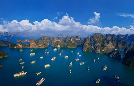 Aerial view of limestone islands with tourist boats in Halong bay, Vietnam