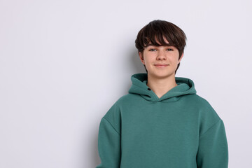 Portrait of teenage boy on white background, space for text