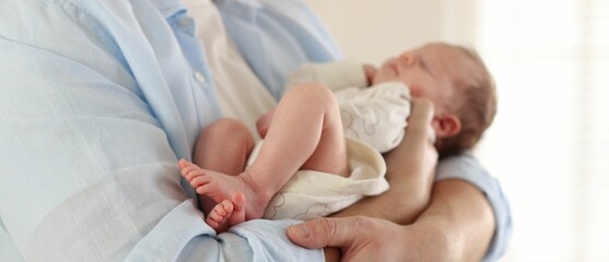 Father with his cute newborn baby indoors, closeup