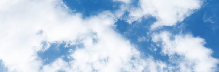 Clear blue sky with a few clouds. The sky is very bright and the clouds are scattered throughout