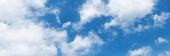 Clear blue sky with a few clouds. The sky is very bright and the clouds are scattered throughout