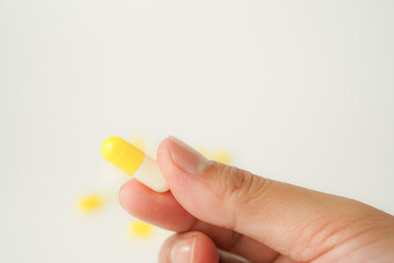 Male hand holding white capsule pill, isolate background, pharmacy, medicine, health care