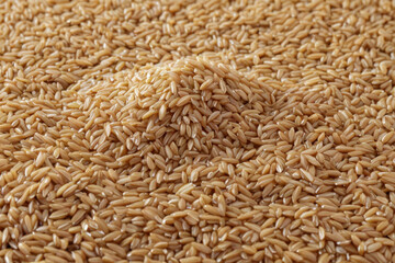 Fototapeta premium A bowl of brown rice sitting on a table, often used as a still life or a food image