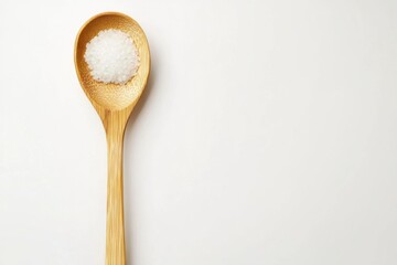 Sugar granules in wooden spoon on white backdrop overhead minimalist food photography studio shot simple concept ingredient
