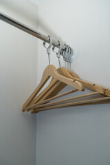 Coat hanger resting on top of other hangers in a simple isolated setting