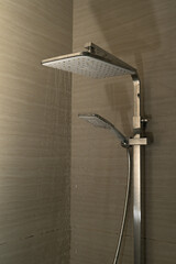 Shower head spraying water inside a modern bathroom