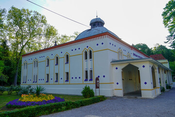 A view of the Daruvar park with architecture and swimming pools on a sunny spring day surrounded by...