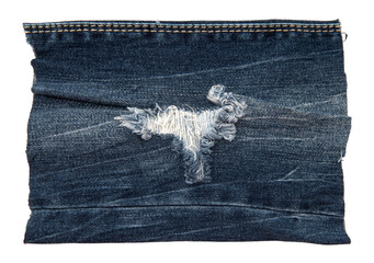 Piece of torn denim on a white background. Denim texture