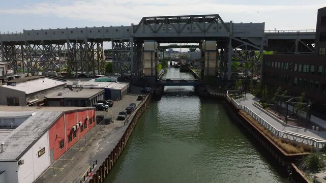 Drone footage of the elevated F train at the 9th Street and 5th Avenue station in Brooklyn, New York. Captured in May daylight, the video highlights the steel subway structure spanning the street, tra