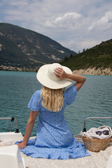 Woman with blonde hair sitting on boat in Southern France