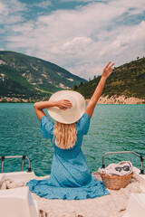 Woman with blonde hair sitting on boat in Southern France