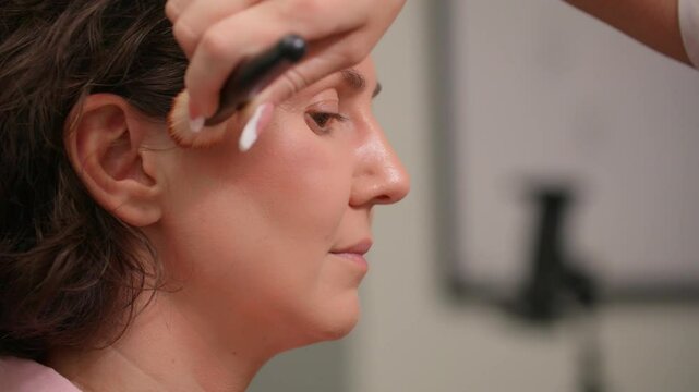 A stylish young Tatar woman gets a stunning makeover at a beauty salon. Fixing her hair, applying mascara, foundation, and enjoying a flawless glam look. UHD video 4k. Beauty salon