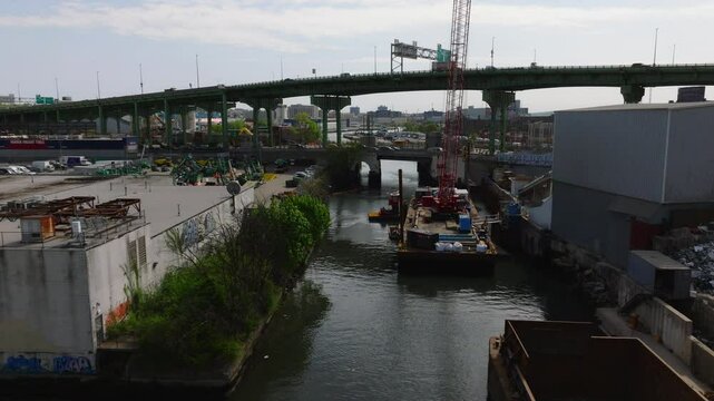 Dynamic drone footage of the Brooklyn-Queens Expressway (BQE) adjacent to the Park Slope neighborhood in Brooklyn, New York. Captured in May daylight, the video contrasts heavy traffic and layered inf