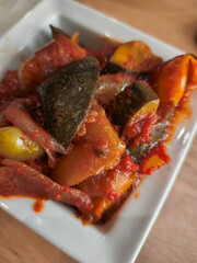 Ratatouille, french stewed vegetable dish, resting in white bowl