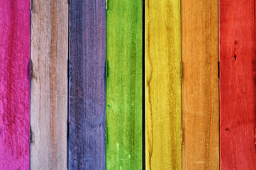 Multi color on wooden plank background.