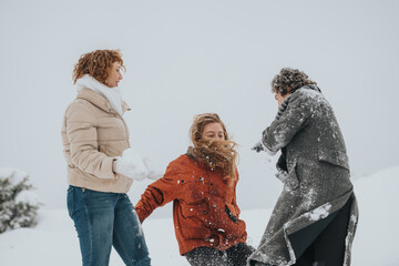Three individuals enjoying a snowball fight on a snowy day, bundled up in winter clothing,...