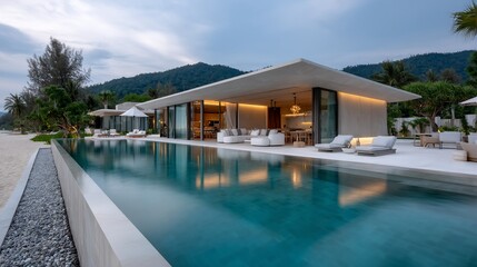 Obraz premium Luxurious beachfront villa with infinity pool, large windows, and serene setting