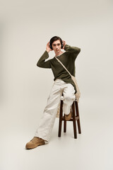 Stylish non binary individual exuding confidence in a minimalist studio setting